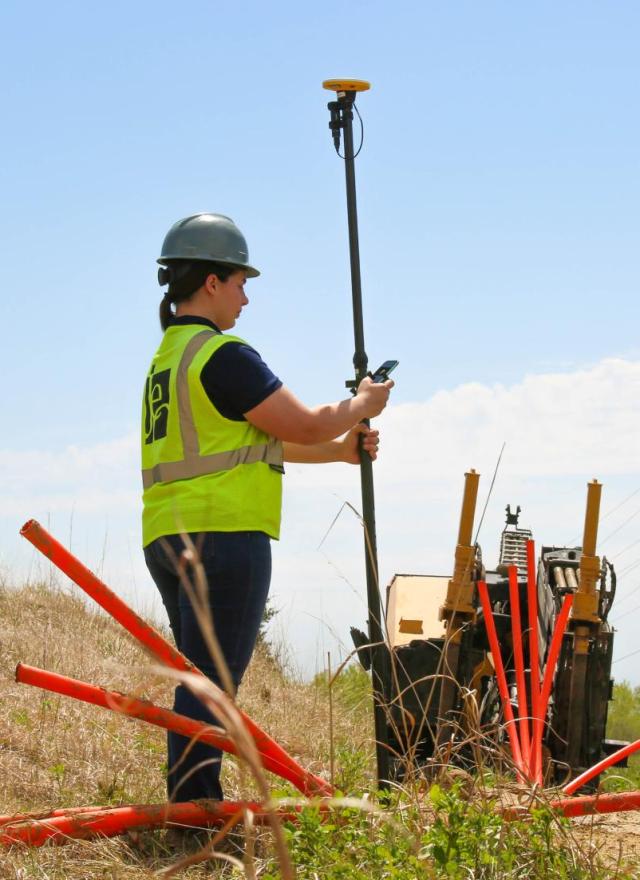 Woman collecting data at broadband fiber site