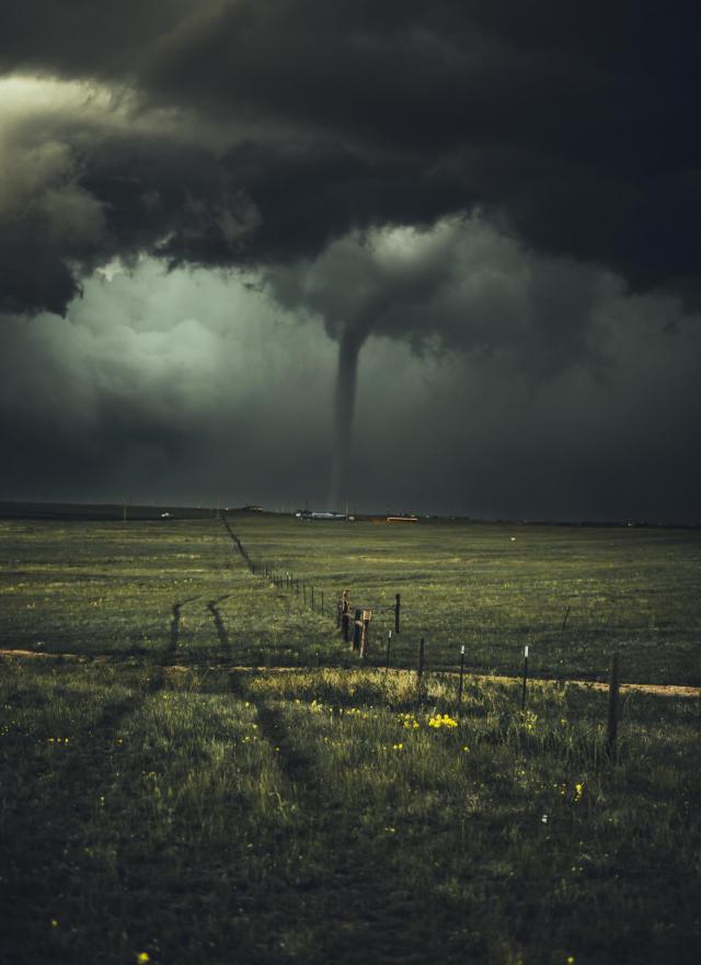 A dark photo of a tornado touched down
