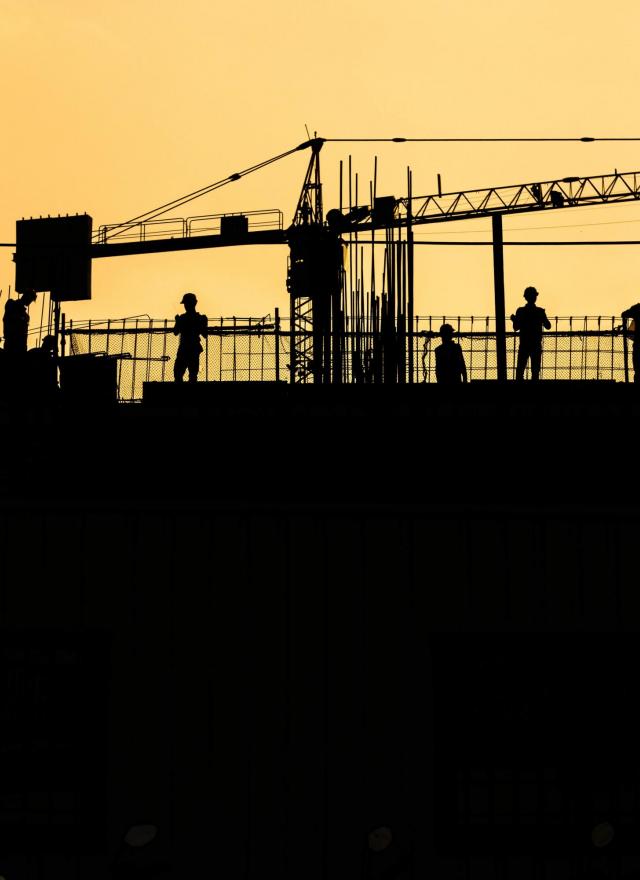Construction silhouette against sunset
