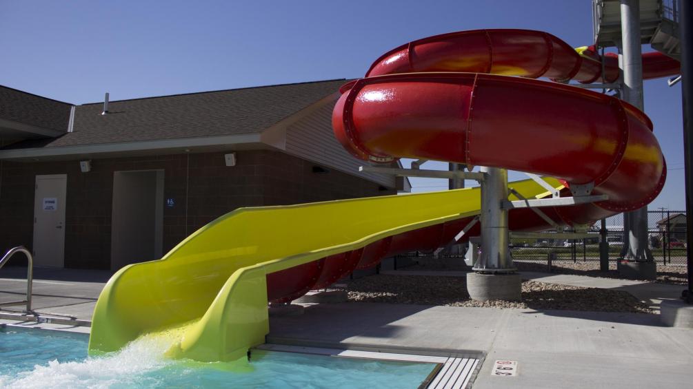 red and yellow water slide with water rushing out